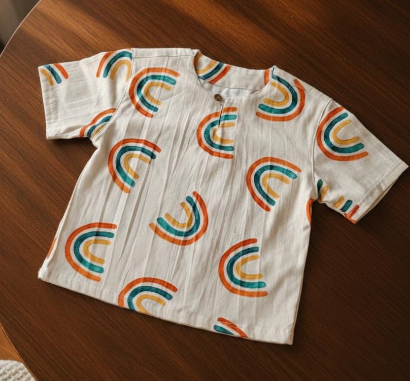 Short-sleeve shirt with rainbow pattern on a wooden surface